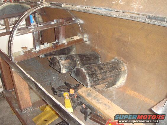 Interior of a custom vehicle frame with two half-pipe sections welded inside