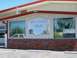 1994 Ford Bronco - Exterior view of the Amsterdam Store building, a painted sign and windows.