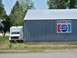 1994 Ford Bronco - A white box truck is parked beside a building with an 'Amsterdam Store' and Pepsi advertisement.