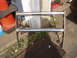 1979 Ford Bronco - Chrome bull bar with two horizontal bars, mounted on brackets, sits on the ground.