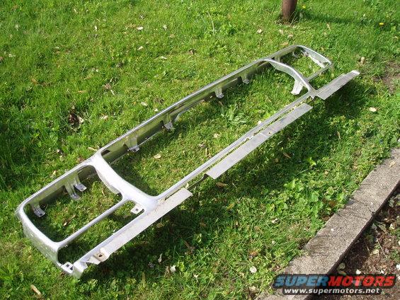 chrome grille assembly lying on grass