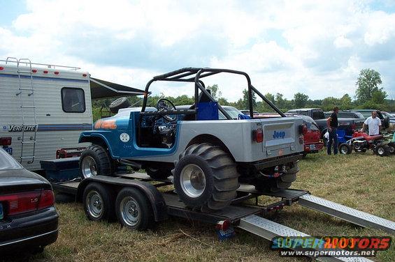 Blue and silver Jeep CJ-7 with large tires on a trailer