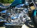 1992 Yamaha Virago - Close-up view of a teal motorcycle's engine and seat, chrome details and 'Virago' badging on the side.