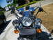 1992 Yamaha Virago - Front view of a motorcycle dual headlights, chrome details, and a leather pouch attached to the handlebars.