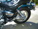 1992 Yamaha Virago - This motorcycle features a black leather seat and teal bodywork, with shiny chrome components.