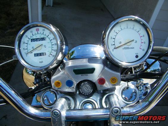 Motorcycle dashboard with speedometer and tachometer gauges