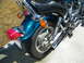 1992 Yamaha Virago - Rear view of a teal motorcycle, showing the fender, wheel, and exhaust system.