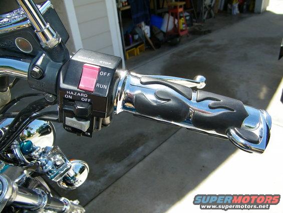 Motorcycle handlebar with engine stop/run switch, hazard lights, and flame-patterned grips