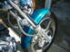 1992 Yamaha Virago - A close-up view of the front wheel assembly and teal fender of a motorcycle.