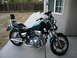1992 Yamaha Virago - This 1992 Yamaha Virago motorcycle is parked on a concrete path next to a building.