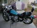1992 Yamaha Virago - A green Yamaha Virago motorcycle is parked on a concrete driveway next to a covered grill.