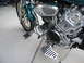 1992 Yamaha Virago - Close-up view of a motorcycle's engine and front wheel, chrome detailing and a green fender.