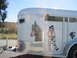 1989 Toyota Pickup/SR5 - A white horse trailer is decorated with various decals, including a pony, a cowgirl, and a rooster, under a bright blue sky.