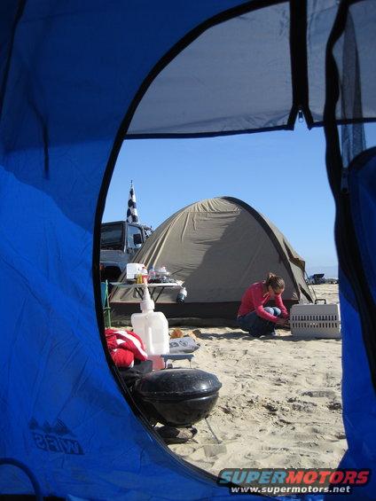 Jeep with checkered flag, campsite on beach