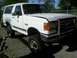 1989 Ford Bronco - This white 1987 Ford Bronco has a red brush guard and appears to have a lifted suspension.