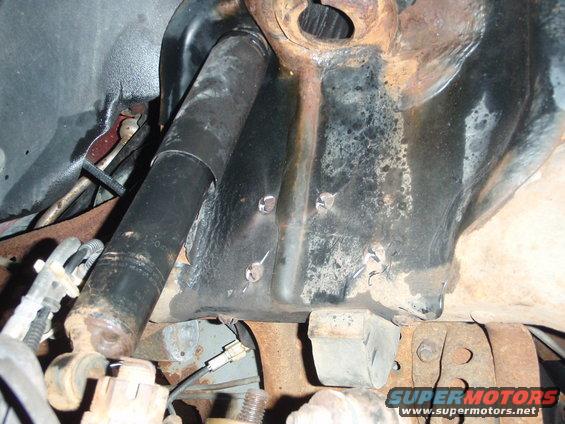 Close-up of rusty suspension components and shock absorber
