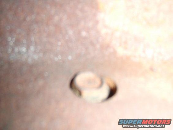 Rusty metal surface with a bolt head visible