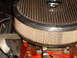 1956 Ford Fairlane - Close-up of an engine air filter assembly with visible text on a lower component.