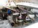 1996 Ford Bronco - Custom suspension component installed in the engine bay of a white vehicle.
