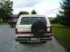 1988 Ford Bronco - The rear of a Ford Bronco is shown, with a spare tire mounted on the back and a license plate visible.