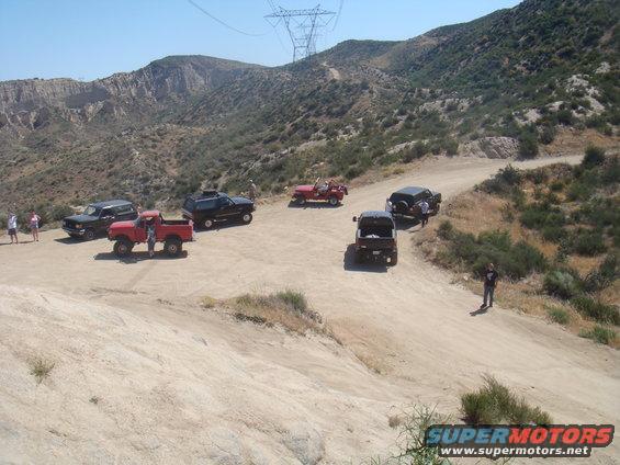 1992 Ford Bronco and other off-road vehicles on a dirt trail