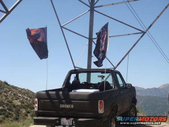 Black 1992 Ford Bronco rear view with two flags flying