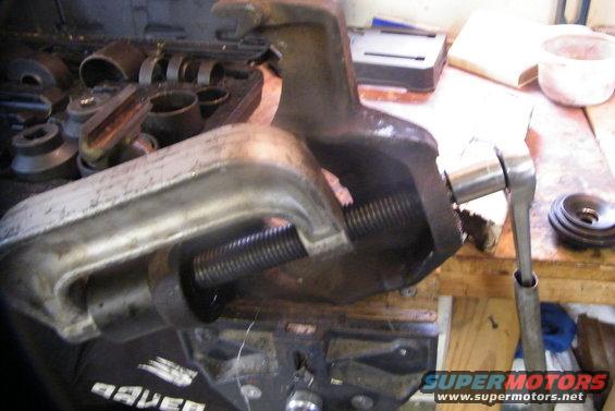 bronco-005.jpg The ball joint press in action.  In this photo the upper ball joint is coming out.  You have to do the lower first in order to getk the upper out.  See the bolt and ratchet coming out the lower joint hole?

You can rent the press at a local store.  It was like $180 at Advance Auto, which is a bit much for a 60 dollar tool, but you get it back.  There's a boat load of presses and receiving cups.  Taking the joints out, you just use the right size receiving cup.  Putting them in, play around with some of the cups to get a good configuration.

Pressing them out is tough.  My leverage you see on the rachet didn't make it.  Breaker bars are like 40 bucks.  I went to home depot and got a piece of 3&quot; dia., 4' long section of black pipe for 12 bucks.  I won't be bending this thing...