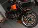 1979 Jeep CJ7 - Motorcycle with orange and black paint scheme, parked in a garage.