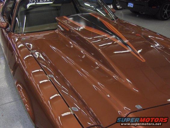 Brown 1979 Chevrolet Camaro with orange and black racing stripes on the hood scoop