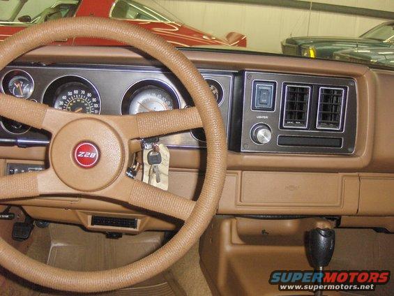 Interior shot of a 1979 Chevrolet Camaro Z28, showing the dashboard, steering wheel, and gear shifter
