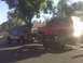 1987 Ford Bronco - A red 1987 Ford Bronco is transported on a trailer towed by a pickup truck.