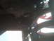 1987 Ford Bronco - Close-up view of the undercarriage, showing red coil springs and suspension parts.