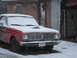 1966 Ford Ranchero - Front view of a 1966 Ford Ranchero covered in snow outside a garage.