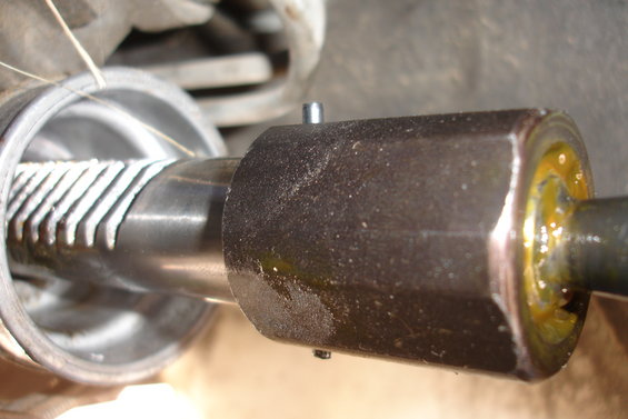 Close-up of a splined shaft with a large nut and a small pin