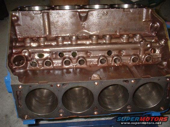 Engine block with cylinder bores visible, some casting marks on top