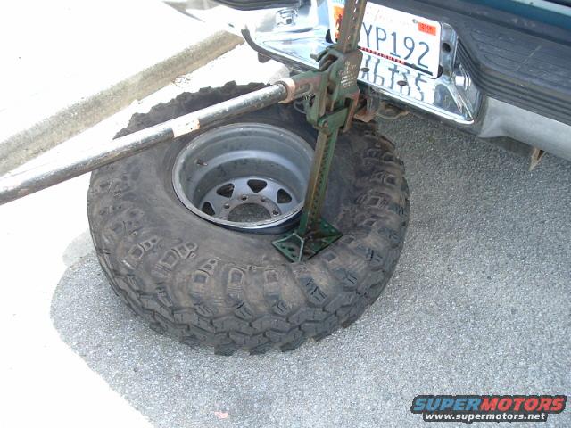 Tire and jack on pavement