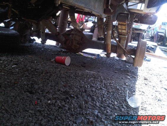 Underside of a vehicle showing leaf springs and differential