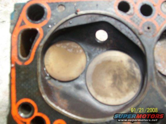 Engine cylinder head showing two valves and orange gasket material. Date stamp '01/21/2008' and 'SUPERMOTORS' logo visible