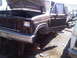1986 Ford Bronco - Junkyard truck, likely from the early 1980s, with its hood and door open and missing front wheels.