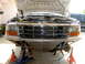 1996 Ford Bronco - Front view of a 1996 Ford Bronco with its hood up, supported by jack stands and an engine hoist.