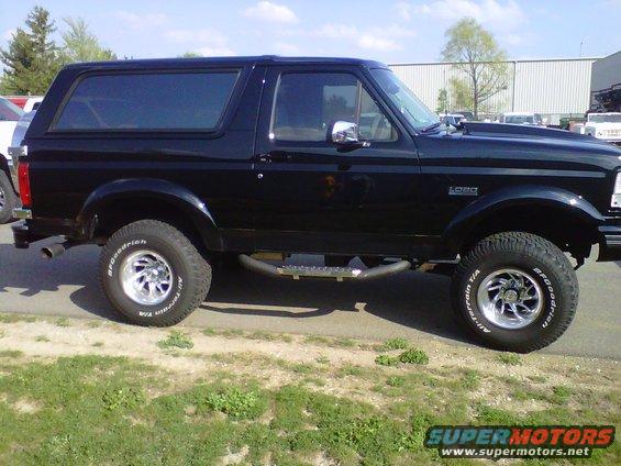 Black Ford Bronco SUV, side view. Lifted with aftermarket wheels and tires