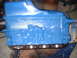 1969 Ford Torino - A blue engine block is shown on a stand, with visible cylinder bores and mounting hardware.