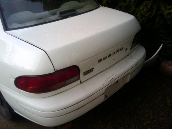 White 1998 Subaru Legacy sedan rear with taillight and SUBARU badging