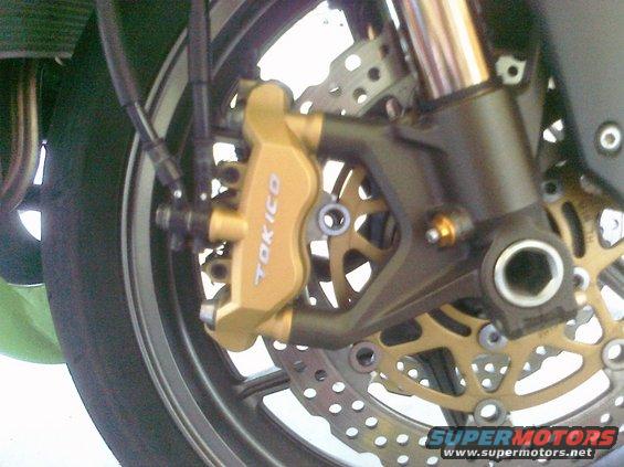 Gold Tokico brake caliper and rotor on a motorcycle wheel