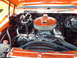 1992 Ford Bronco - The engine bay is bright orange, with a miniature truck placed on top of the air filter assembly.