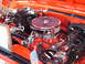 1992 Ford Bronco - Close-up of a modified V8 engine bay with chrome accents and an American flag detail.