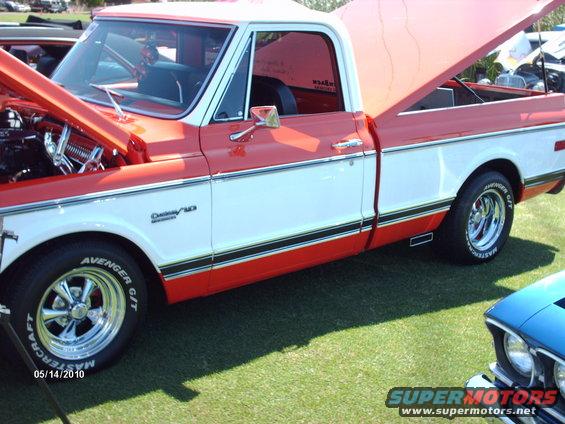 Red and white 1972 Chevrolet C10 pickup truck, side view, hood and tailgate open