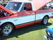 1992 Ford Bronco - A two-tone red and white Chevrolet C10 pickup truck is displayed with its hood and tailgate open at a car show.
