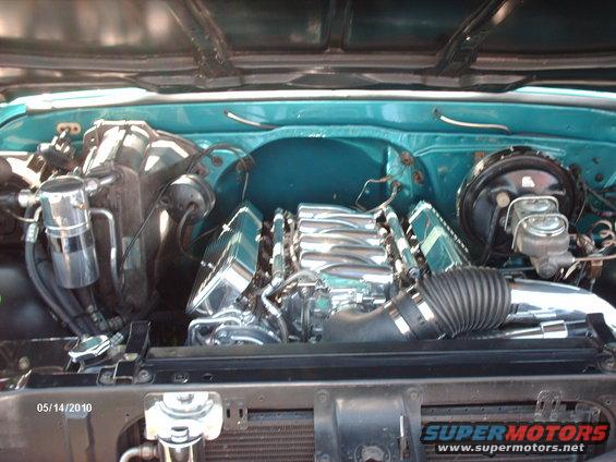 Engine bay with chrome intake manifold and teal paint