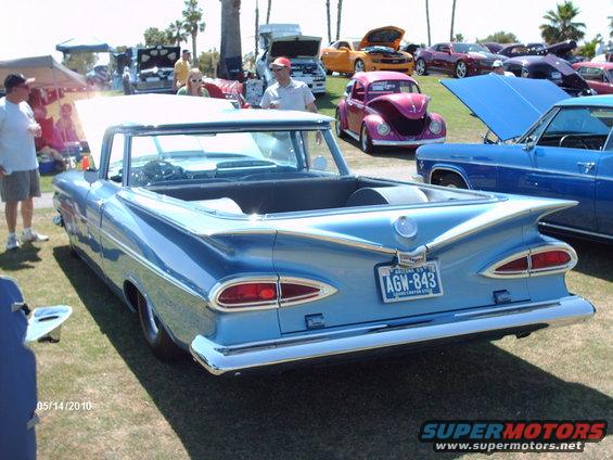 Light blue 1959 Chevrolet El Camino convertible with prominent rear fins and chrome bumper, seen from the rear